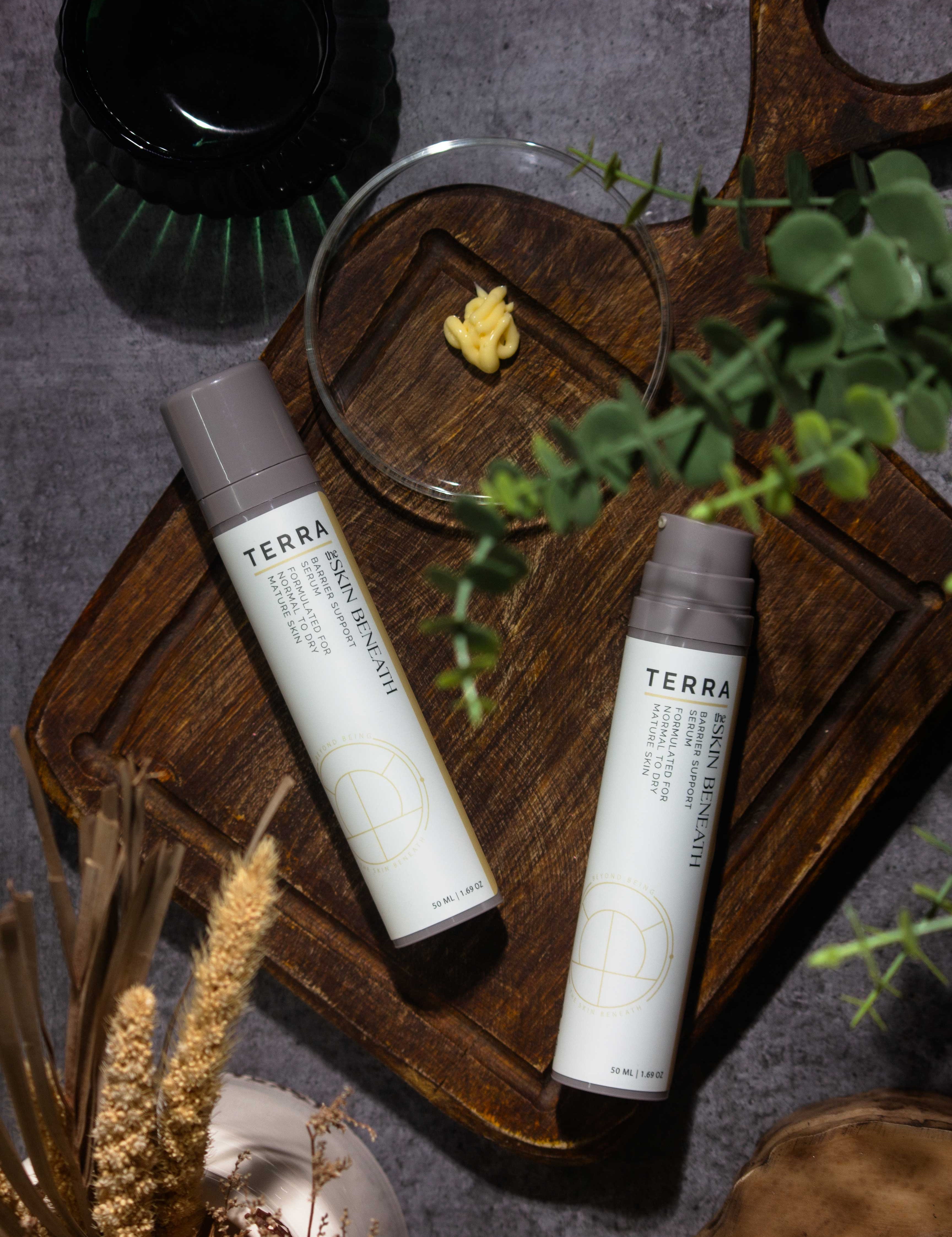 Terra serum flat lay with kokum butter and cedar, Ayurvedic barrier-care ritual showcasing the creamy texture