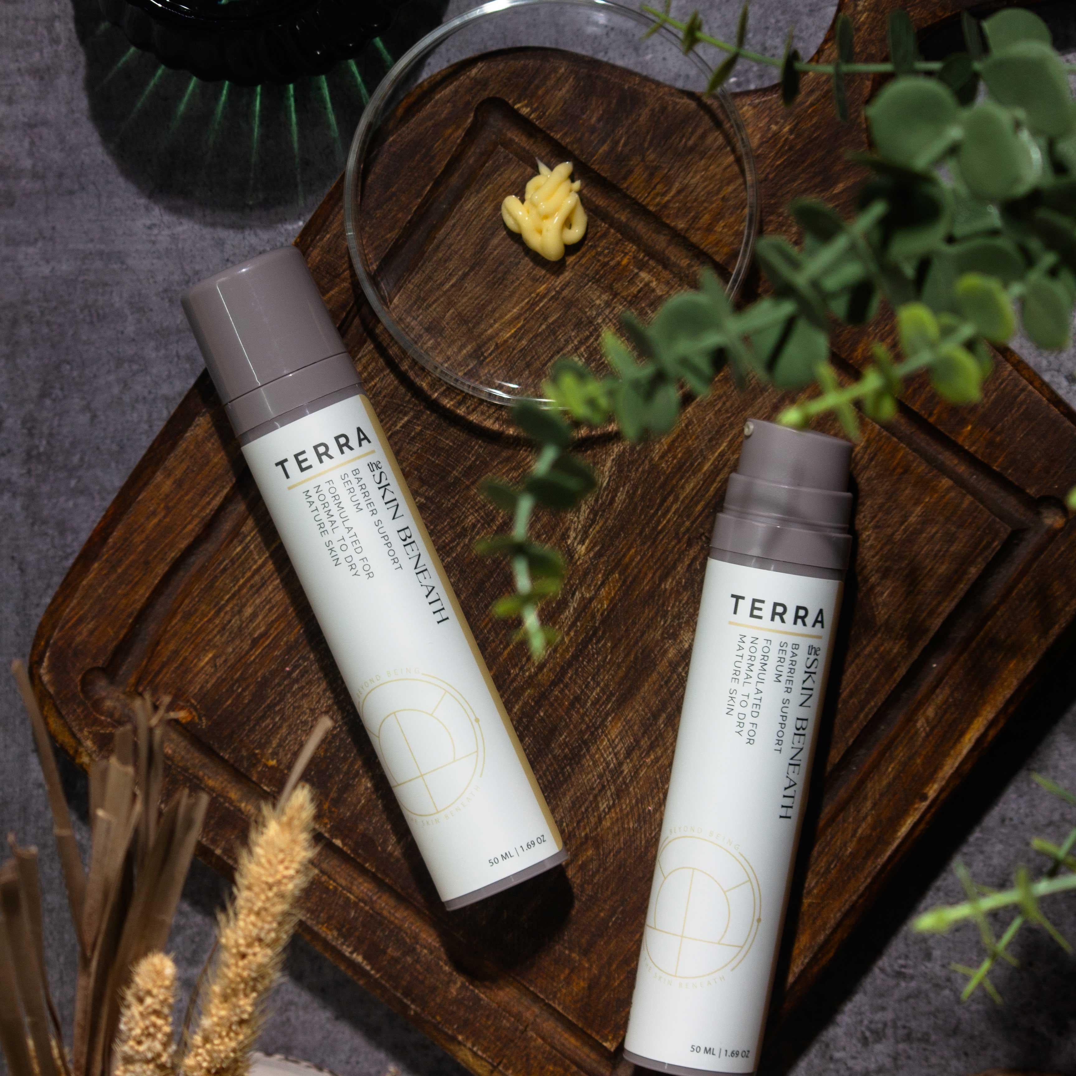 Terra serum flat lay with kokum butter and cedar, Ayurvedic barrier-care ritual showcasing the creamy texture